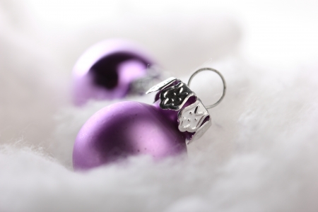 pink christmas balls on artificial snow with white backgroundの写真素材