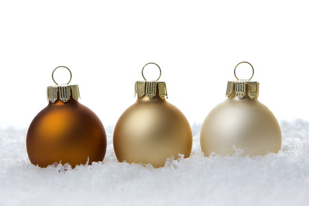 creme christmas balls on artificial snowの写真素材