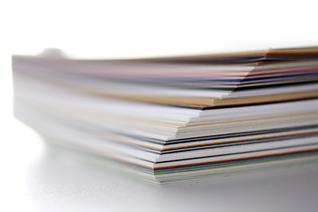 separating stacked sheets to organize a folder with white backgroundの写真素材