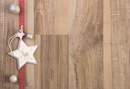 moravian star white with red ribbon on wooden backgroundの写真素材