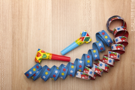 streamers and confetti as decoration for parties, sylvester with wooden backgroundの写真素材