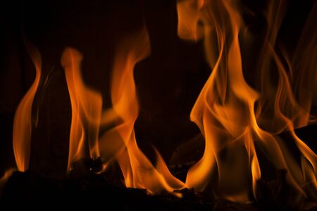 Fire in the fireplace on a black backgroundの写真素材