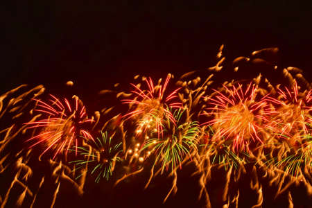 Colorful fireworks of various colors over night sky. New Year celebration.