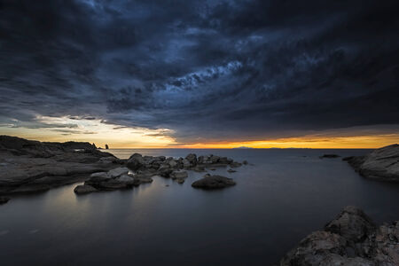 The storm is approaching the beach at sunsetの写真素材