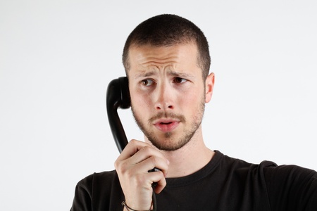 young man talking at the telephoneの写真素材