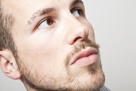 young man's face, looking upの写真素材