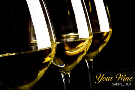 three glasses of white wine on black backgroundの写真素材