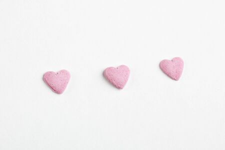 heart shaped candy sweets on white backgroundの写真素材