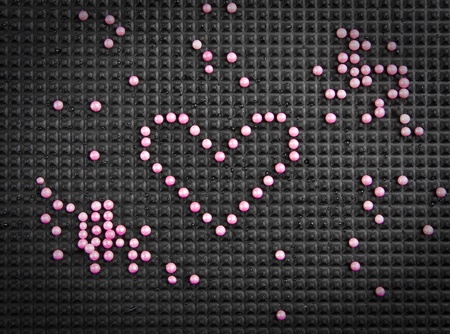heart shape made with candy on rubber black backgroundの写真素材