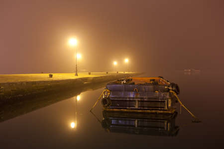 foggy seascape port at nightの写真素材