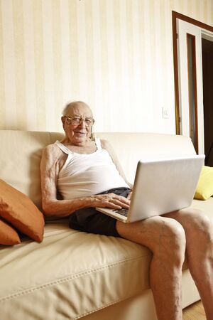 elder man with laptopの写真素材