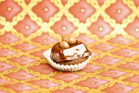 Beautiful little cake on colorful wallpaper backgroundの写真素材