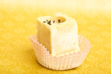 Beautiful little cake on colorful wallpaper backgroundの写真素材