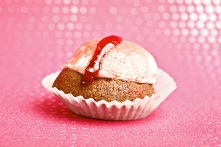 Beautiful little cake on colorful wallpaper backgroundの写真素材
