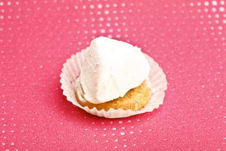 Beautiful little cake on colorful wallpaper backgroundの写真素材