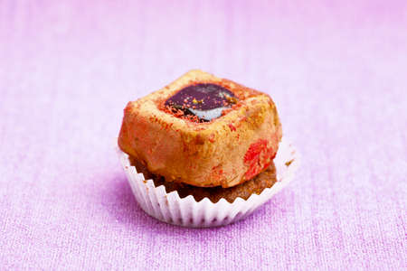 Beautiful little cake on colorful wallpaper backgroundの写真素材