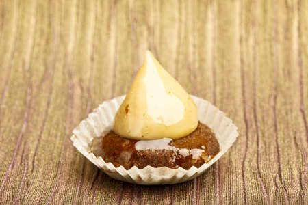 Beautiful little cake on colorful wallpaper backgroundの写真素材
