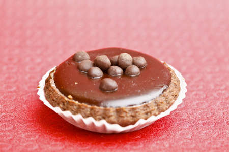 Beautiful little cake on colorful wallpaper backgroundの写真素材