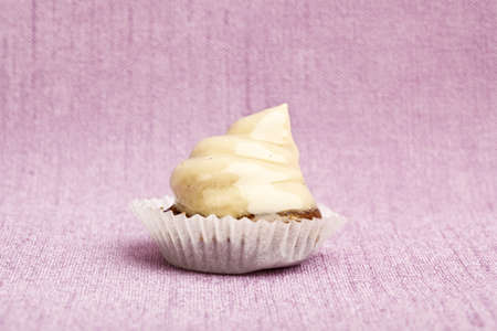Beautiful little cake on colorful wallpaper backgroundの写真素材