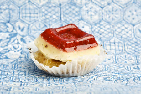 Beautiful little cake on colorful wallpaper backgroundの写真素材