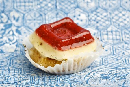 Beautiful little cake on colorful wallpaper backgroundの写真素材