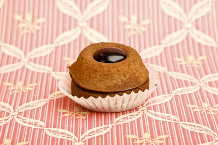 Beautiful little cake on colorful wallpaper backgroundの写真素材