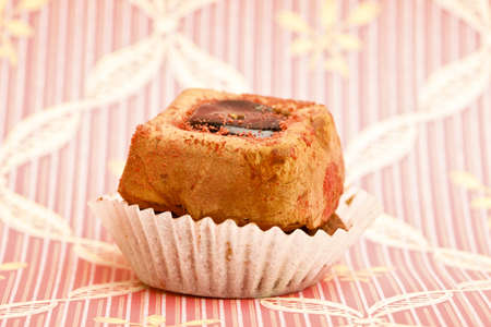 Beautiful little cake on colorful wallpaper backgroundの写真素材