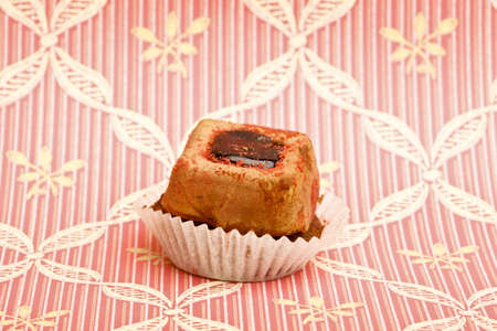 Beautiful little cake on colorful wallpaper backgroundの写真素材