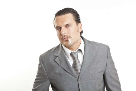 portrait of a cool elegant young man smoking a sigaretteの写真素材