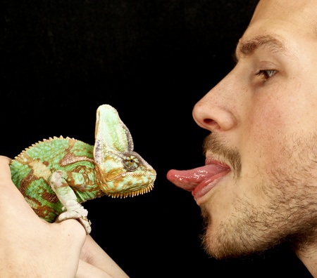 boy kissing a chameleonの写真素材