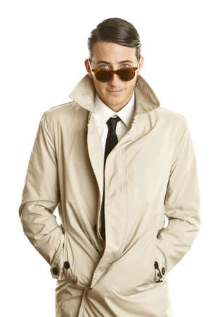 fashion young man with sunglasses and trenchcoatの写真素材