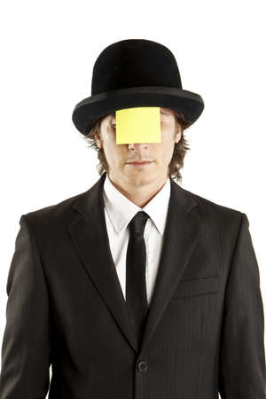 man with blank note on the face with hatの写真素材