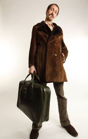 funny vintage young man with suitcaseの写真素材
