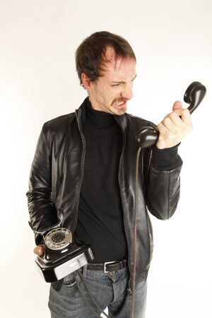 angry young man at the telephoneの写真素材