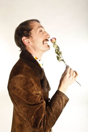 portrait of a vintage young man with roseの写真素材