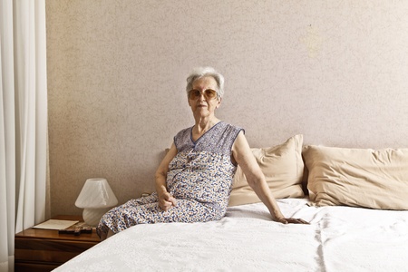 old lady in the bedroomの写真素材
