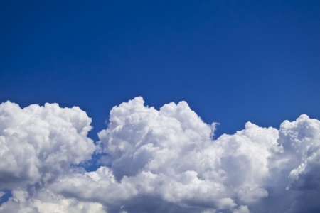 white fluffy clouds over blue sky landscapeの写真素材