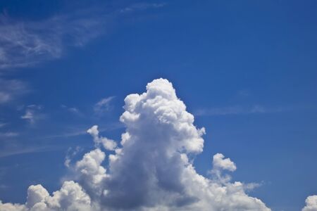 white fluffy clouds over blue sky landscapeの写真素材