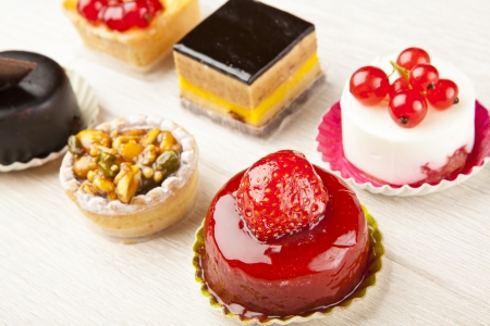 Different sort of beautiful pastry, small colorful sweet cakesの写真素材