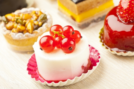 Different sort of beautiful pastry, small colorful sweet cakesの写真素材