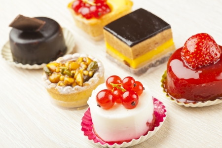 Different sort of beautiful pastry, small colorful sweet cakesの写真素材
