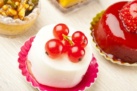 Different sort of beautiful pastry, small colorful sweet cakesの写真素材