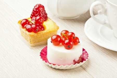 fruit pastry little cake with tea cup on white wooden tableの写真素材