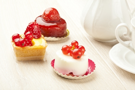 fruit pastry little cake with tea cup on white wooden tableの写真素材