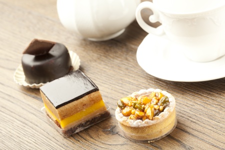 chocolate pastry little cake with tea cup on  wooden tableの写真素材