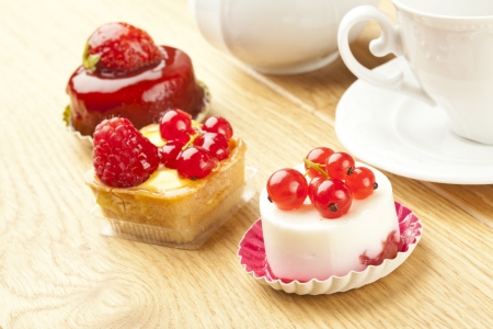 fruit pastry little cake with tea cup on  wooden tableの写真素材