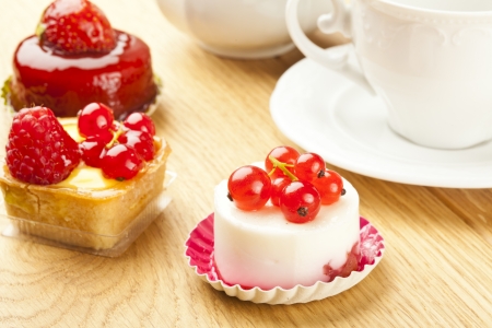 fruit pastry little cake with tea cup on  wooden tableの写真素材