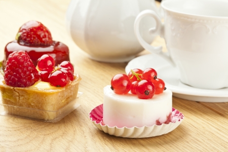 fruit pastry little cake with tea cup on  wooden tableの写真素材