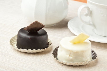 chocolate pastry little cake with tea cup on  wooden tableの写真素材