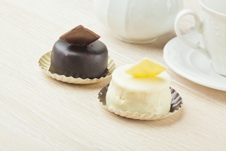 chocolate pastry little cake with tea cup on  wooden tableの写真素材